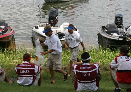 The University of Kentucky takes their fish to the weigh-in stage, while the other teams keep an eye on the competition.