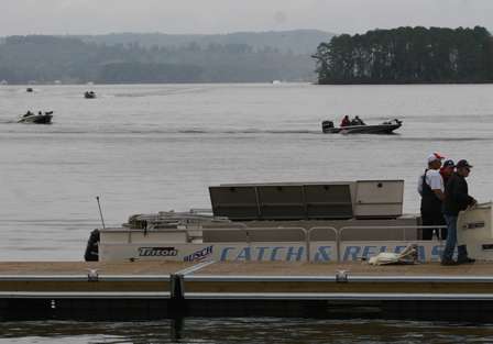 Boats stream in toward the docks as the live-release boat waits for the fish to arrive.