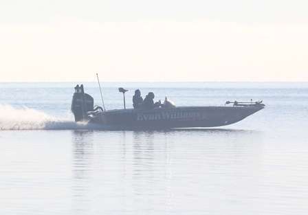 Jason Quinn runs by the outside edge of the grassbed where several of the anglers are fishing.