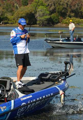Omori jerks a small keeper into the boat.