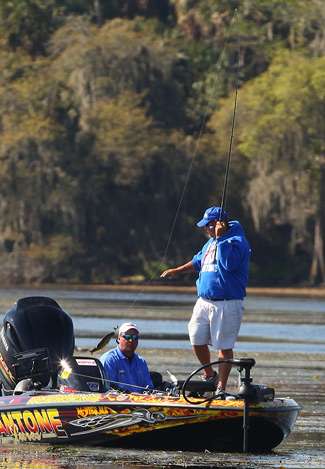 Matt Herren swings a small fish into the boat.
