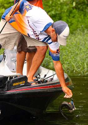 Lee carefully releases the bass into Hurricane Lake.