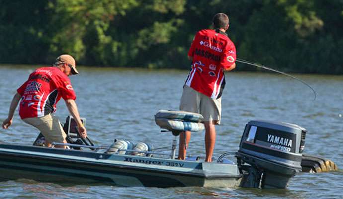 Lasher connects with a fish and Hooks moves to grab the net. 