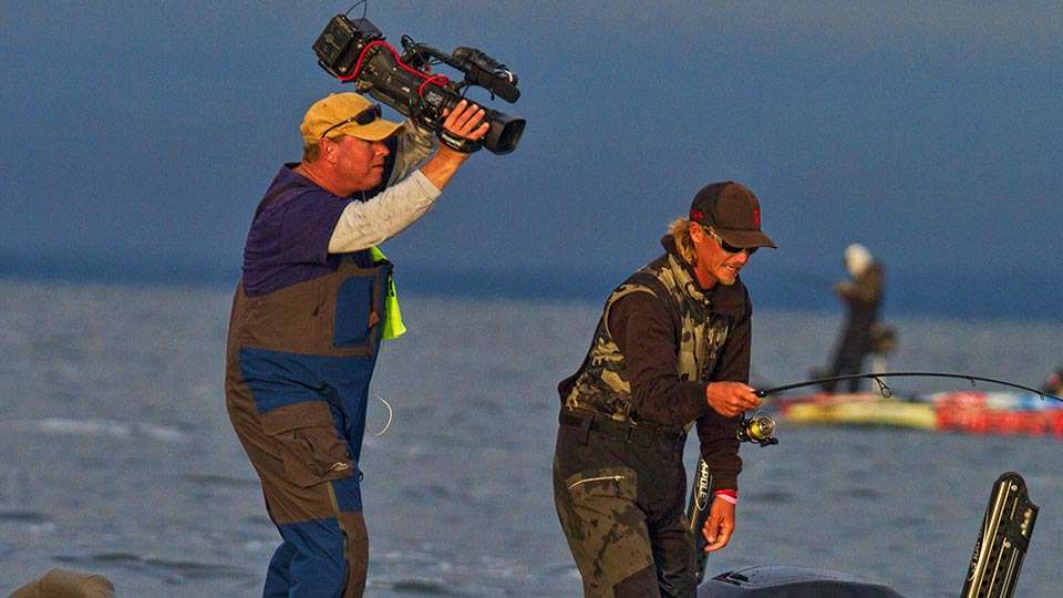 Mason was often seen with camera held high to get the best vantage point for the action unfolding in front of him.