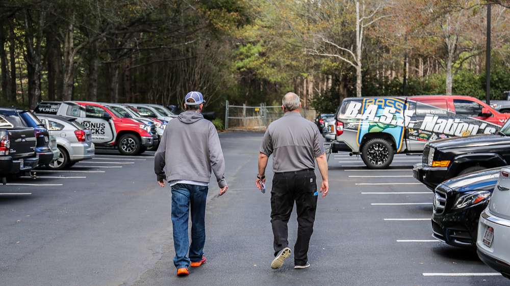 B.A.S.S. Nation Director Jon Stewart and Darrell walk through the parking lot...