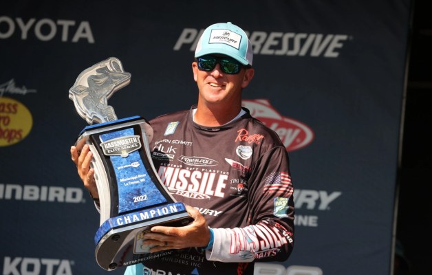 Bryan Schmitt holds a Bassmaster Elite Series trophy on the weigh-in stage