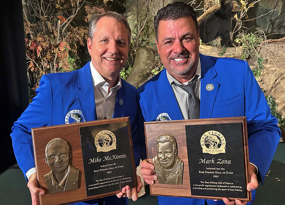 Mike McKinnis and Mark Zona pose with their Hall of Fame plaques.